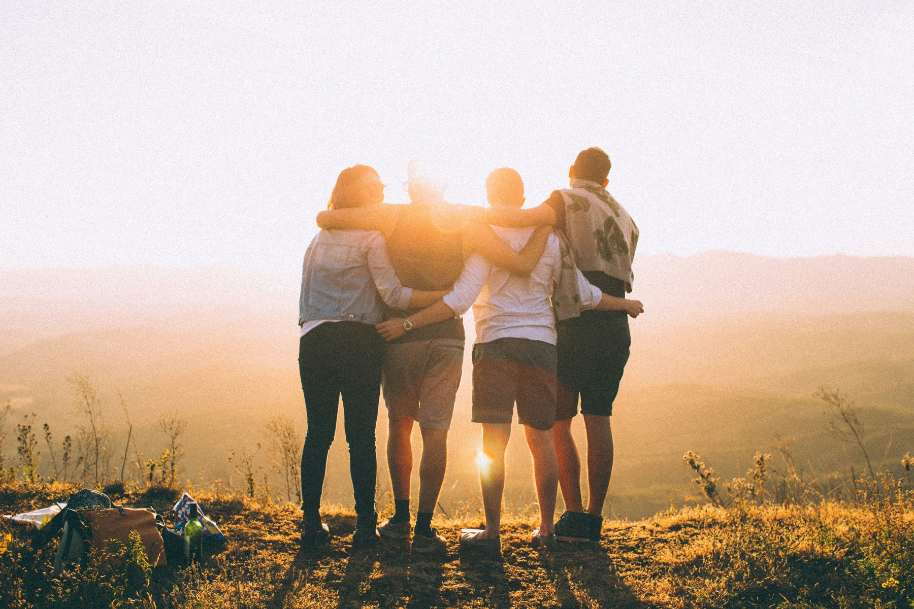 A small group standing together at sunset.