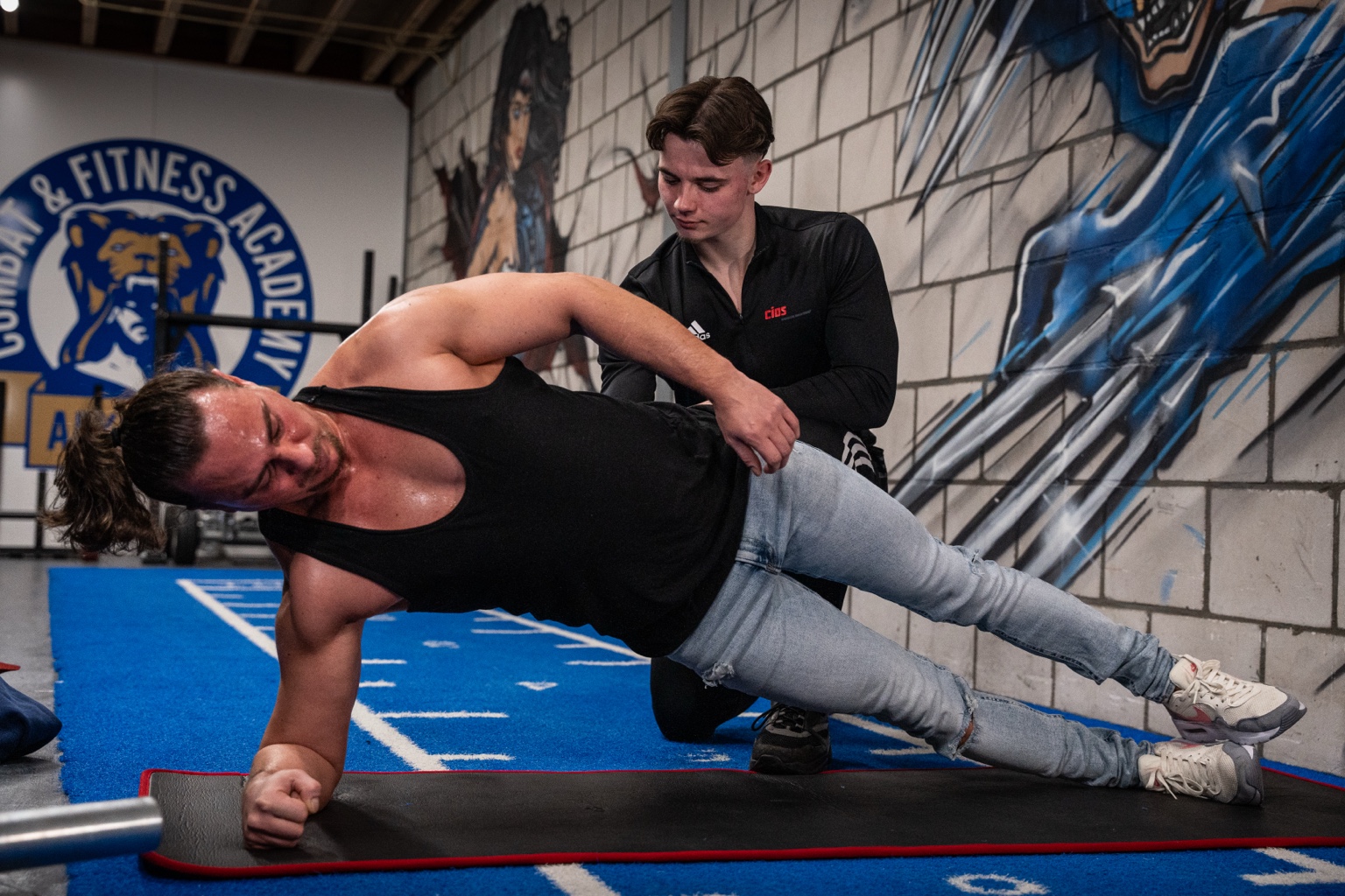 Robin Kramps correcting side-plank technique during personal coaching