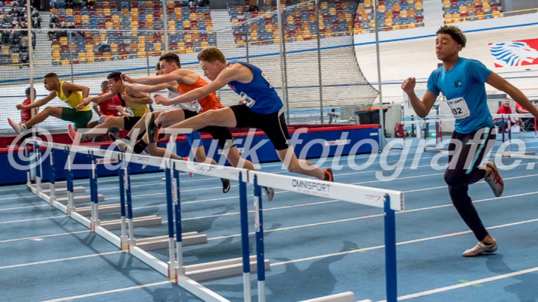 Close view of an indoor hurdles race.
